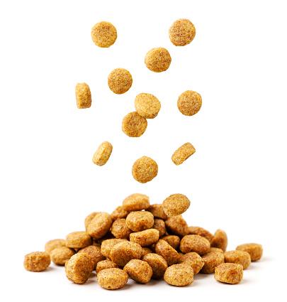 Dog Biscuits falls on a pile close-up on a white background. Isolated